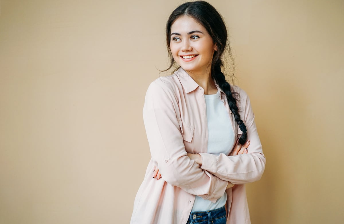 Young Smiling Brunette on Beige Background